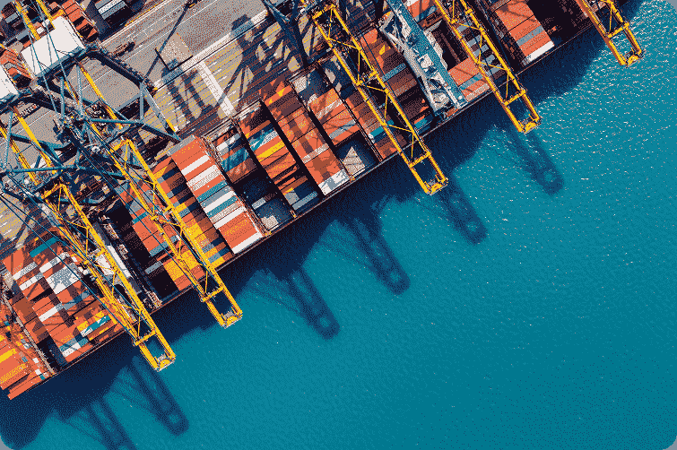 Aerial view of shipping containers and cranes at a container terminal