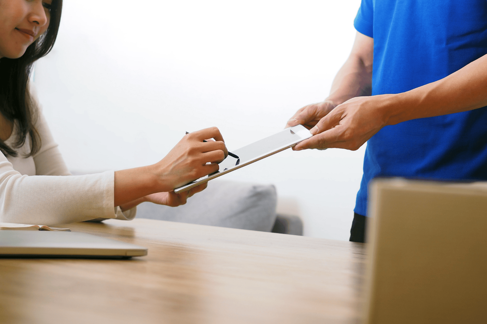 An image of a person signing a delivery form