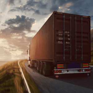 Interstate freight transport truck driving along a coastal highway at sunset