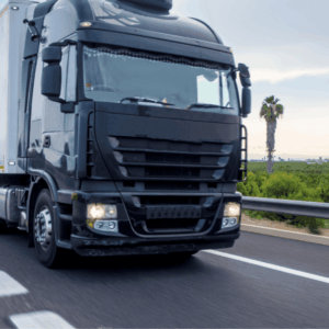 A large truck on a highway, showing long‑distance transport to highlight interstate freight cost.